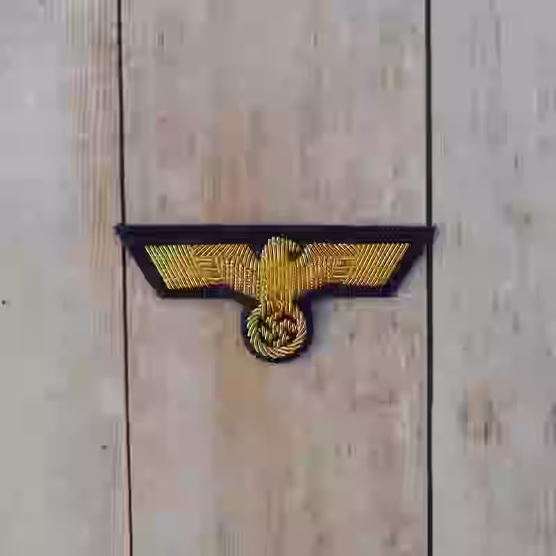 Kriegsmarine Officer's Hand Embroidered Cap Eagle - WWII-era Kriegsmarine officers hand embroidered cap eagle with gold wire on darkblue wool background.