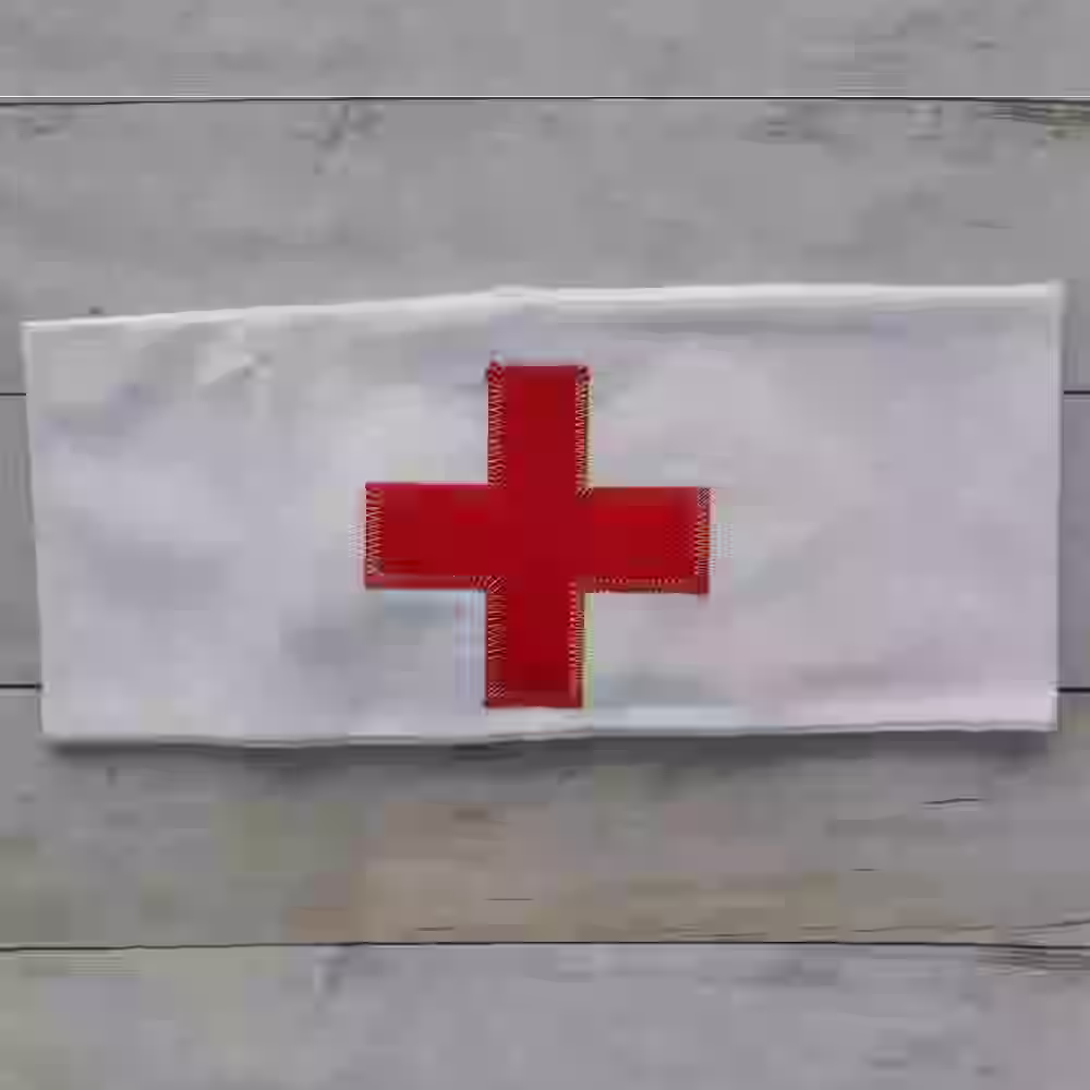 German Sanitary Armband - WWII-era German sanitary armband with red cross on white cotton background.